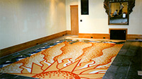 Sunburst with Vine Border custom design for a tiled floor by Eugenia Talbott in the process of transforming a floor to a work of art